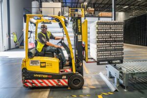 Forklift course Brisbane - yellow forklift with worker lifting loads