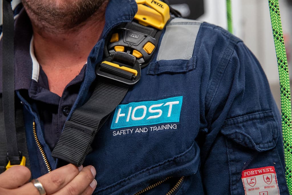 Icam training - close up of host logo on worker shirt